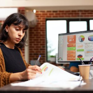 Businesswoman analyzing marketing graph working at company strategy in startup office