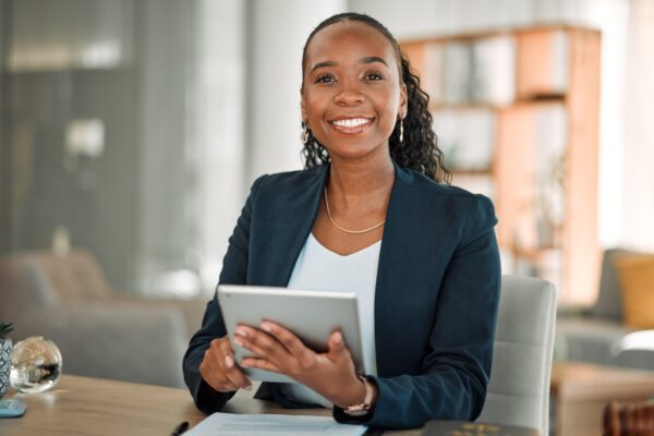 Lawyer, portrait and black woman with tablet in office for research, email and smile. African attor